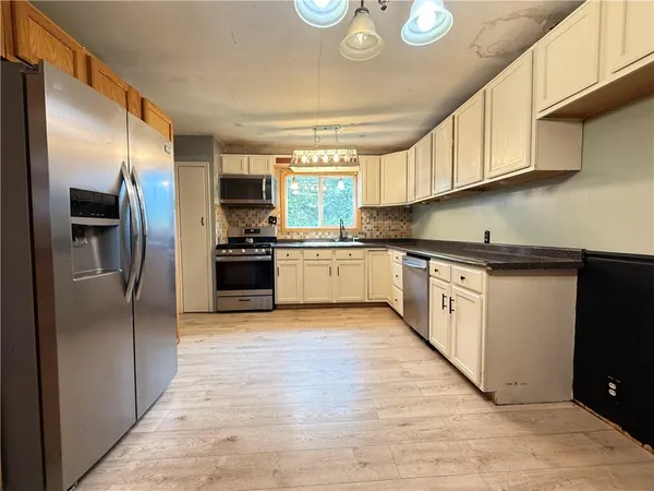 a kitchen with cabinets a sink and dishwasher