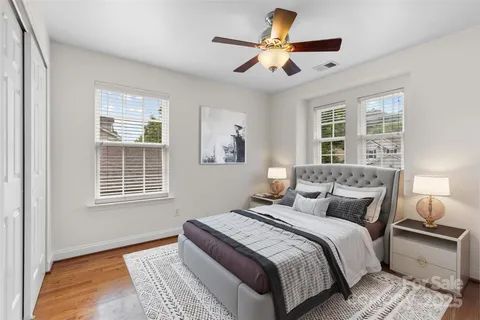 a bedroom with a large bed and a large window