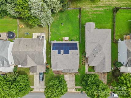 an aerial view of a house with a yard