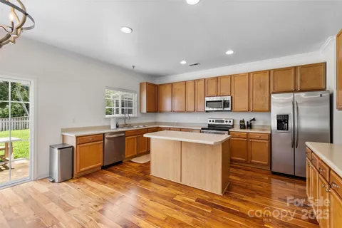 a kitchen with granite countertop stainless steel appliances and wooden cabinets