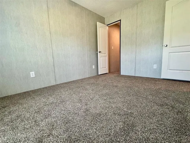 a view of an empty room and closet area