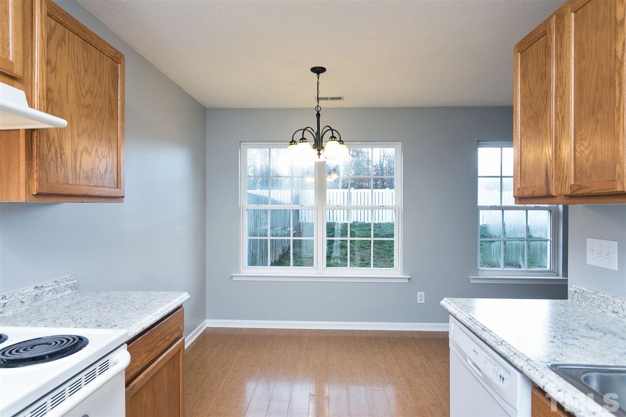 8108 Inverbrass Court Raleigh, NC 27616 - Photo 11 of 25 a kitchen with a sink stove and cabinets