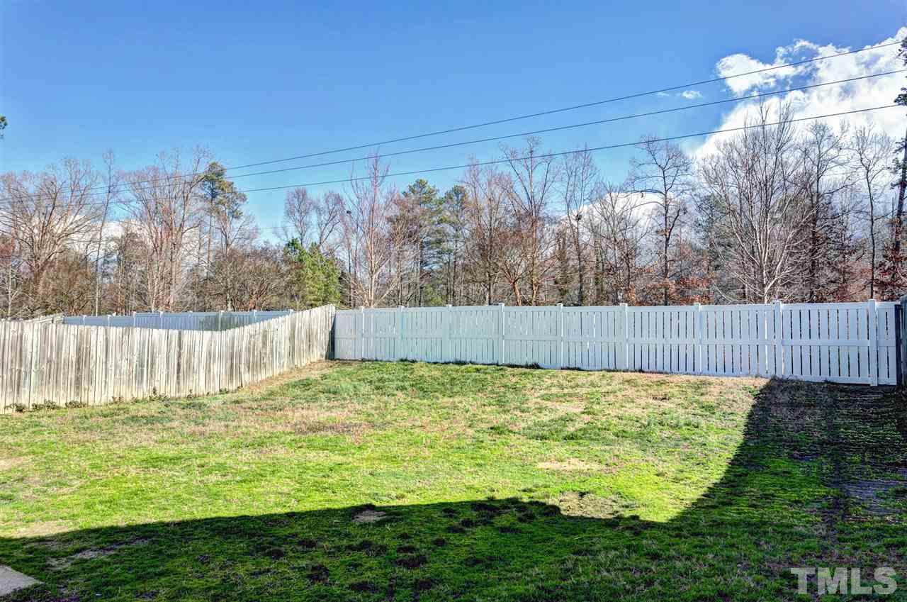 8108 Inverbrass Court Raleigh, NC 27616 - Photo 21 of 25 a view of a backyard with a fence and plants