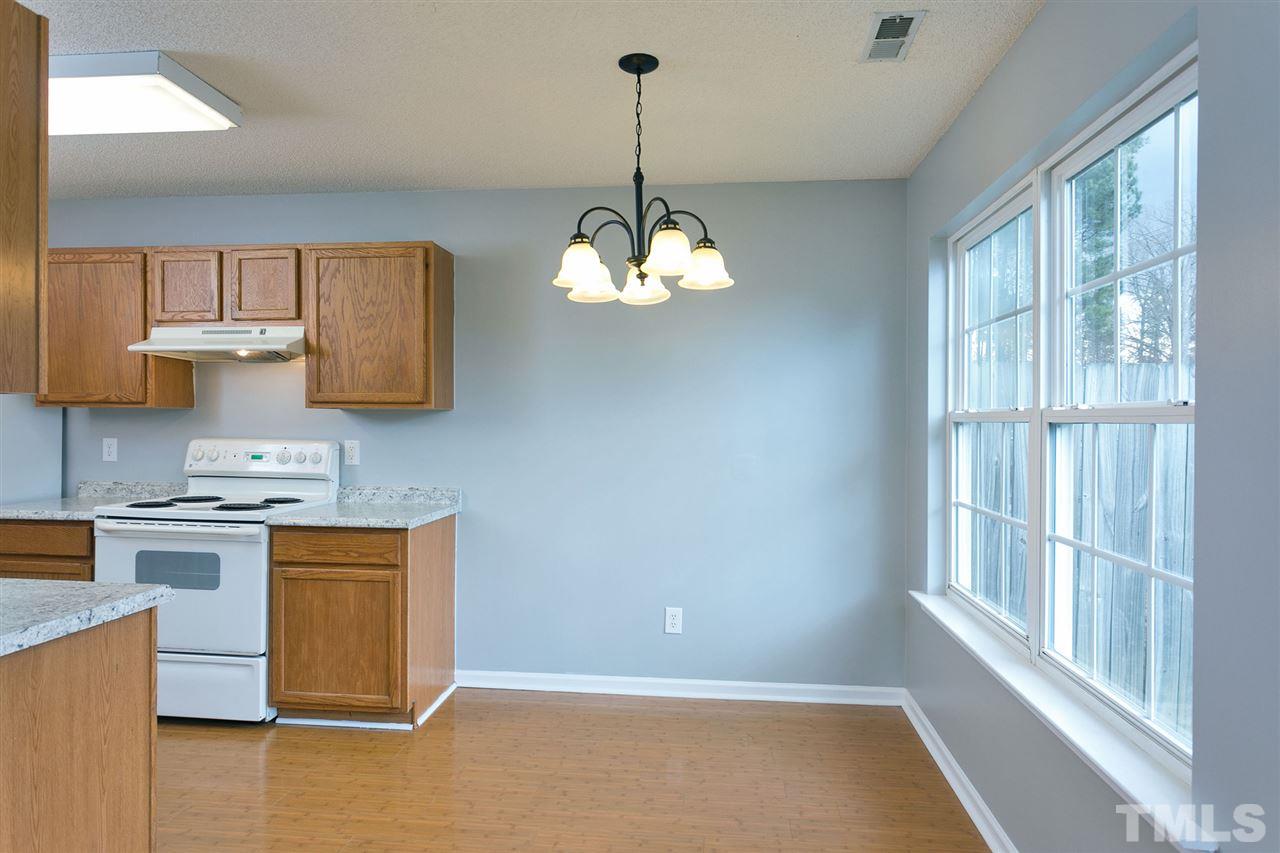 8108 Inverbrass Court Raleigh, NC 27616 - Photo 6 of 25 a kitchen with stainless steel appliances granite countertop a stove a sink dishwasher and a microwave oven with cabinets