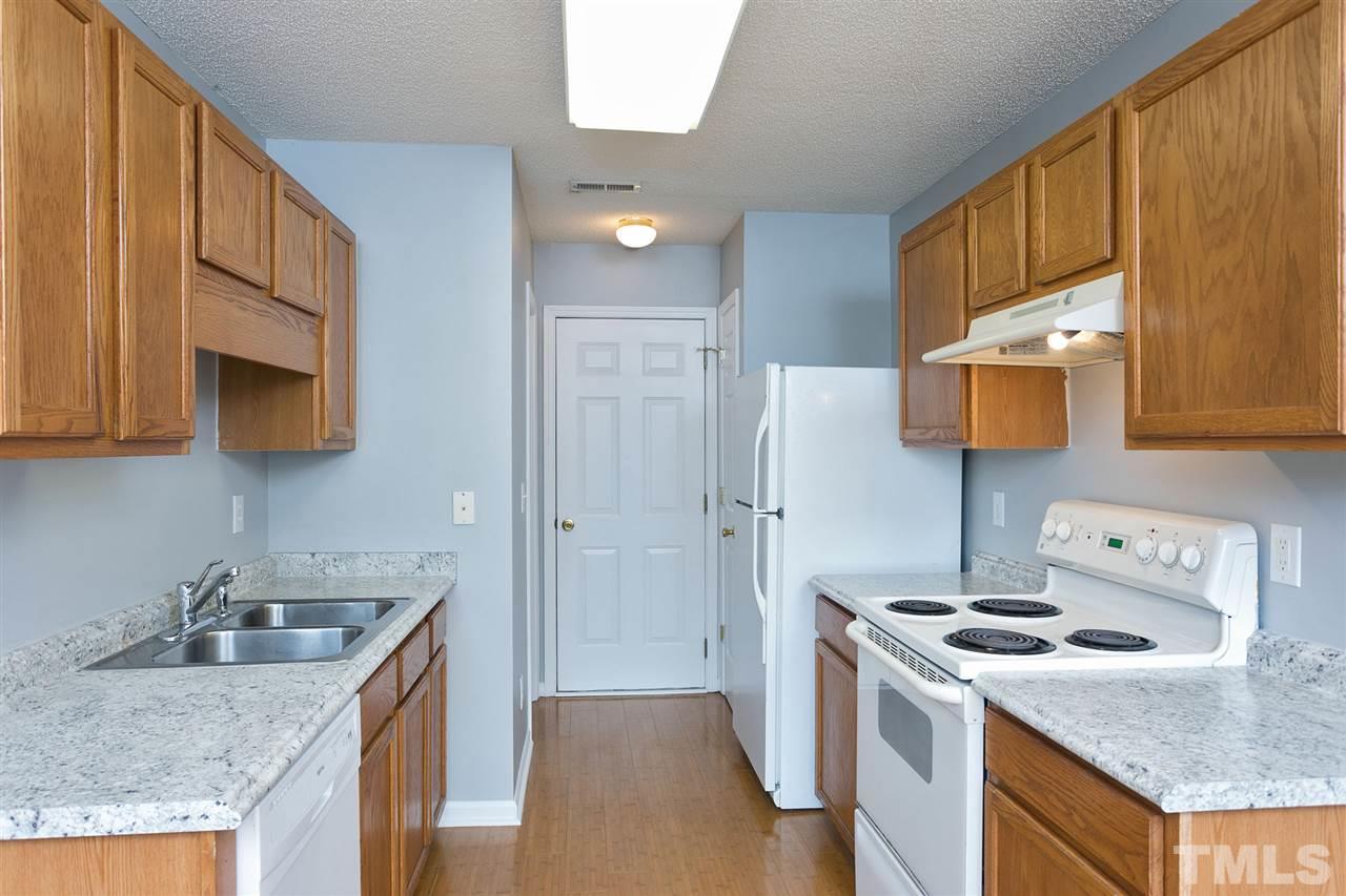 8108 Inverbrass Court Raleigh, NC 27616 - Photo 7 of 25 a kitchen with stainless steel appliances granite countertop a sink stove and refrigerator