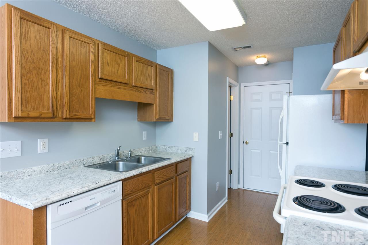 8108 Inverbrass Court Raleigh, NC 27616 - Photo 8 of 25 a kitchen with stainless steel appliances granite countertop a sink stove and cabinets