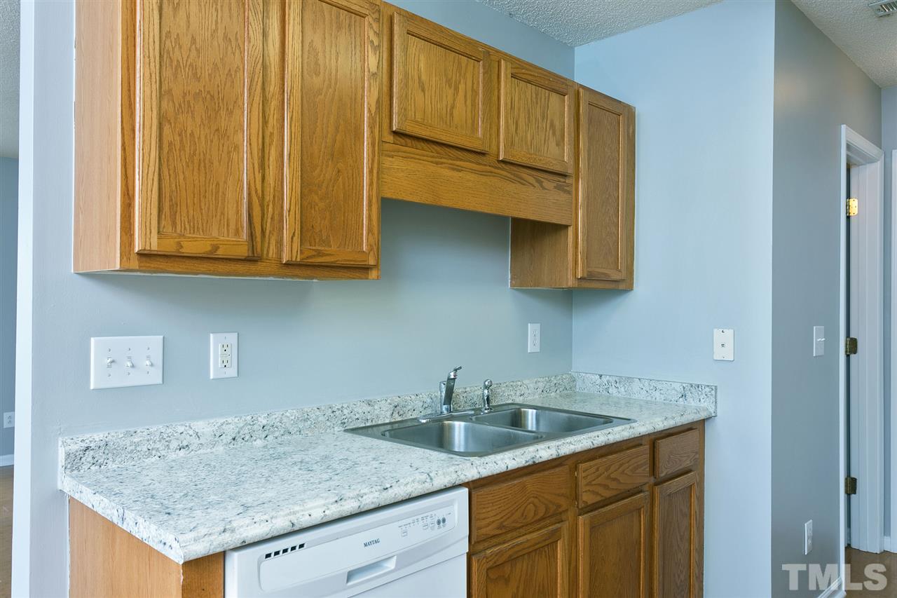 8108 Inverbrass Court Raleigh, NC 27616 - Photo 10 of 25 a kitchen with stainless steel appliances granite countertop a sink and cabinets