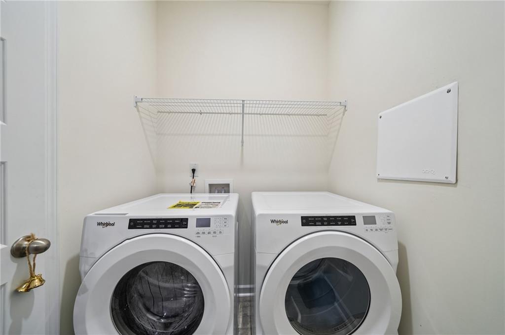 8592 Seabiscuit Road Lithonia, GA 30058 - Photo 18 of 25 a view of a storage & utility room with dryer and washer