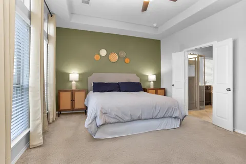 a bedroom with a bed and a painting on the wall