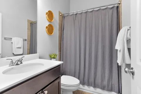 a bathroom with a sink vanity mirror and toilet