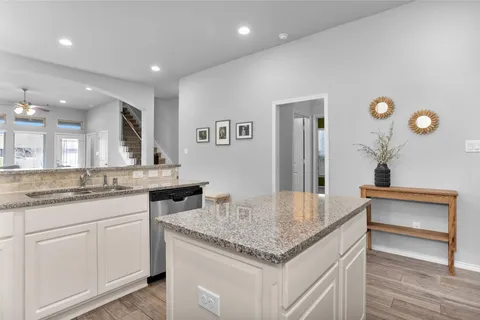 a kitchen with granite countertop a stove and a sink