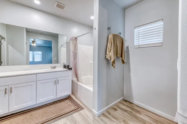a living room with hard wood floor furniture and a flat screen tv