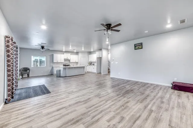 a kitchen with granite countertop white cabinets and white appliances