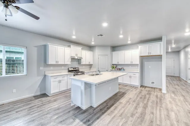 a kitchen with a sink stove and cabinets