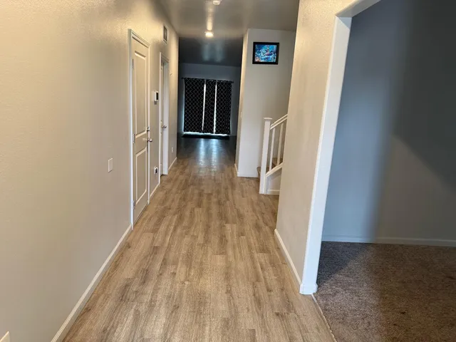 a room with a sink cabinets and wooden floor