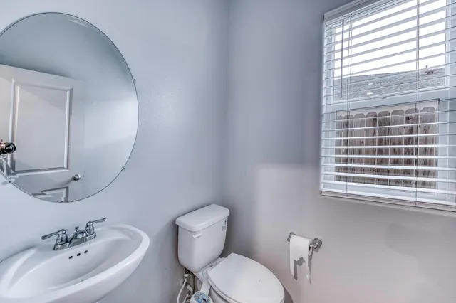 a view of a hallway with wooden floor and entryway