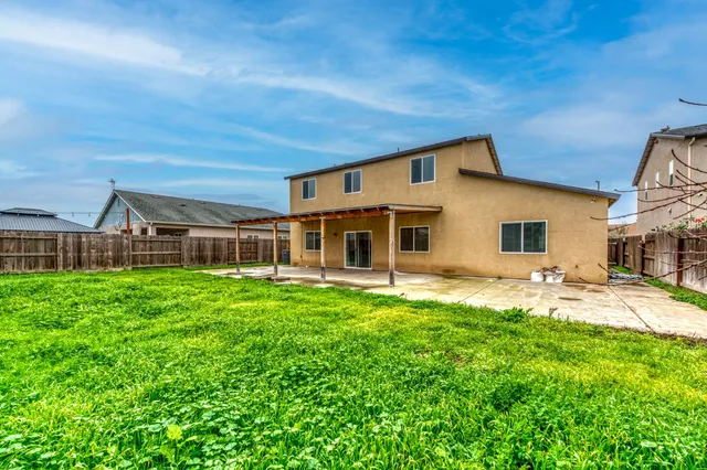 a view of backyard with large windows