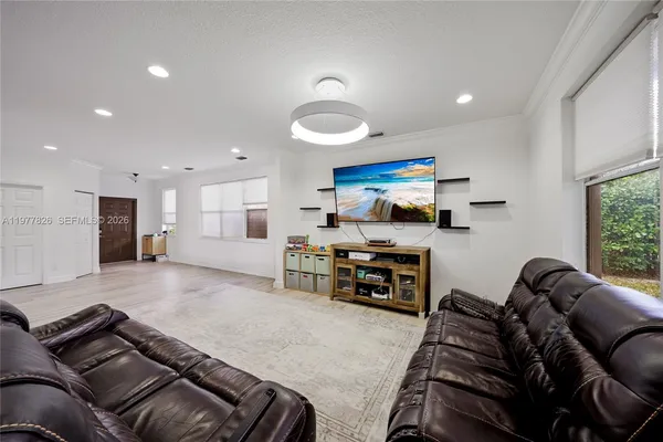 a living room with furniture and kitchen view