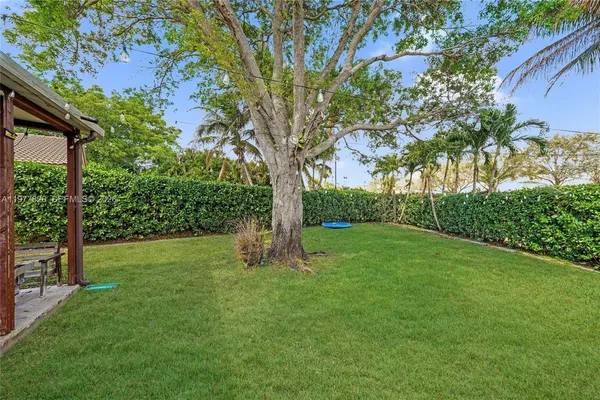 a view of green field with trees