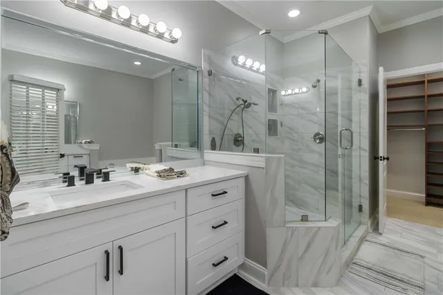 a bathroom with a double vanity sink mirror double and shower