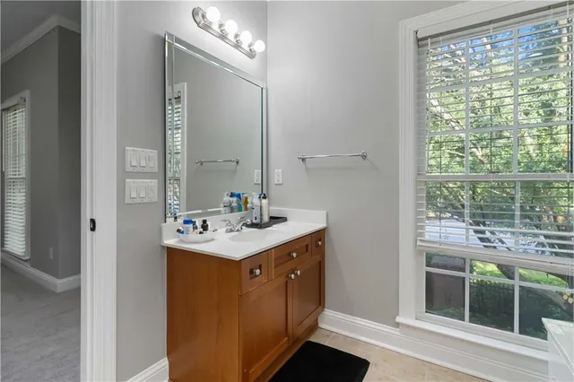 a bathroom with a sink a mirror and a window
