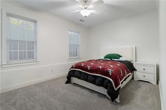 a spacious bedroom with a bed and window
