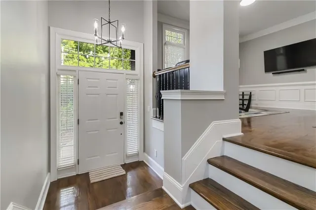 a view of a livingroom with wooden floor and kitchen space with a sink