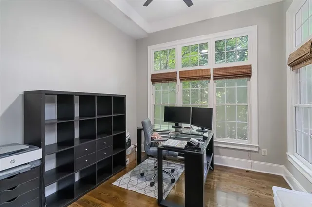 a view of a workspace with furniture and a window