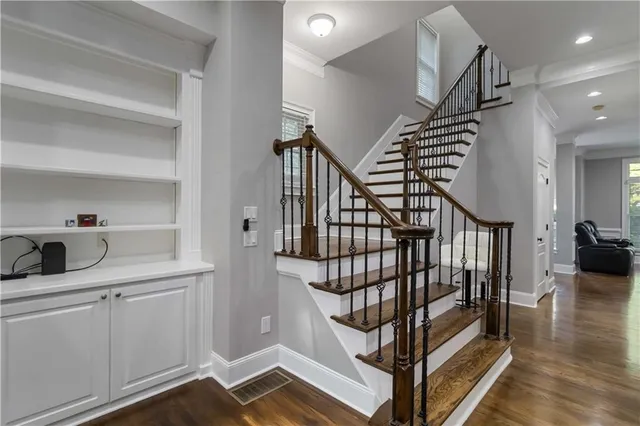 a view of entryway and hall with wooden floor