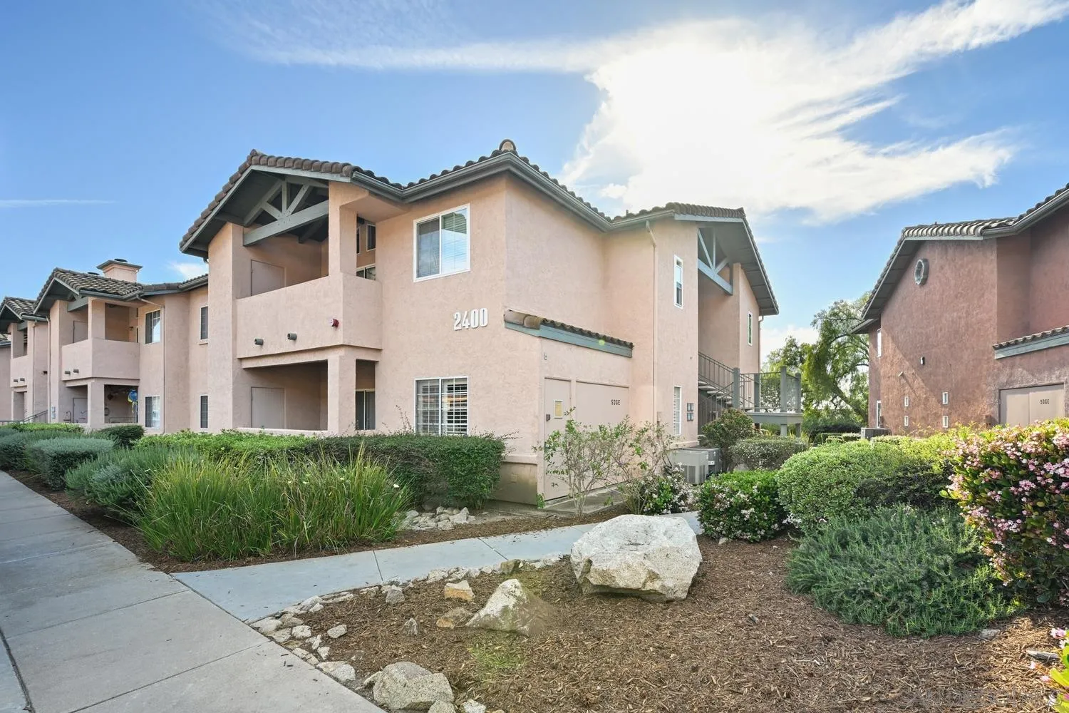 a view of a white house with windows and plants