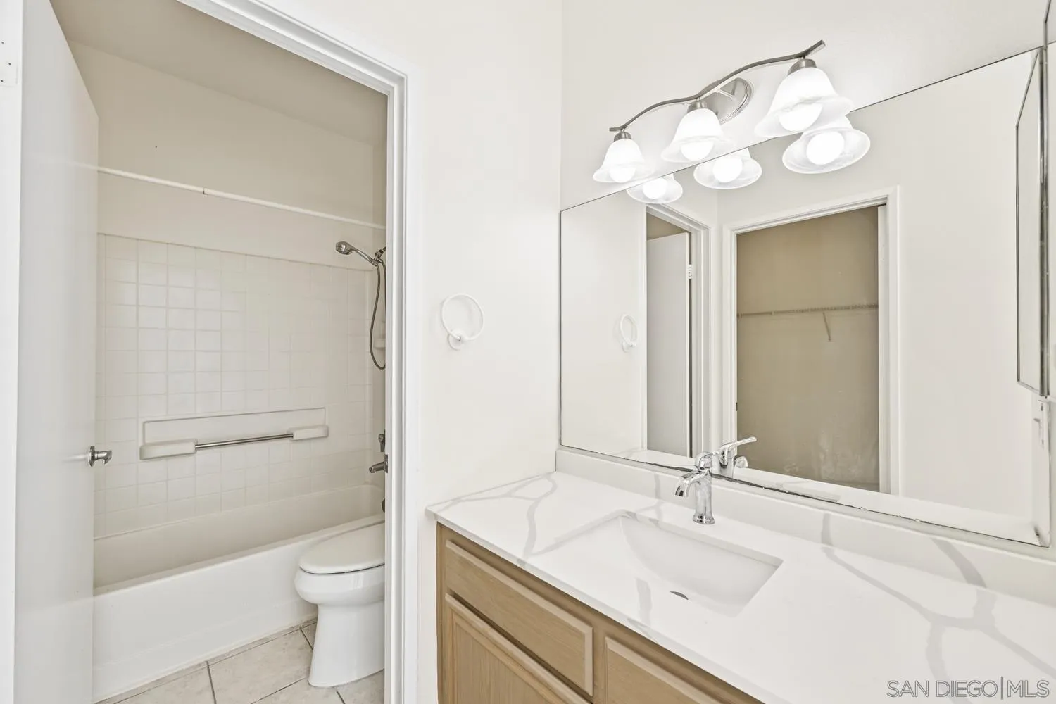17161 Alva Road, Unit 2416 San Diego, CA 92127 - Photo 15 of 26 a bathroom with a sink a toilet and a large mirror