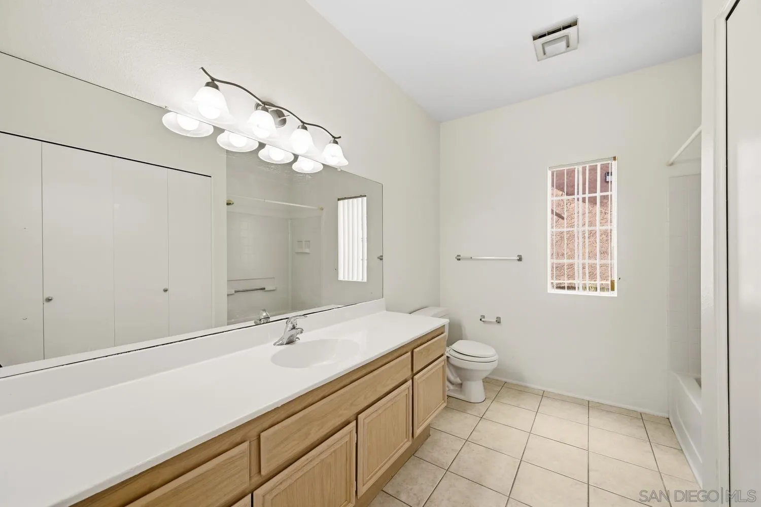 17161 Alva Road, Unit 2416 San Diego, CA 92127 - Photo 18 of 26 a spacious bathroom with a granite countertop sink a toilet and a mirror