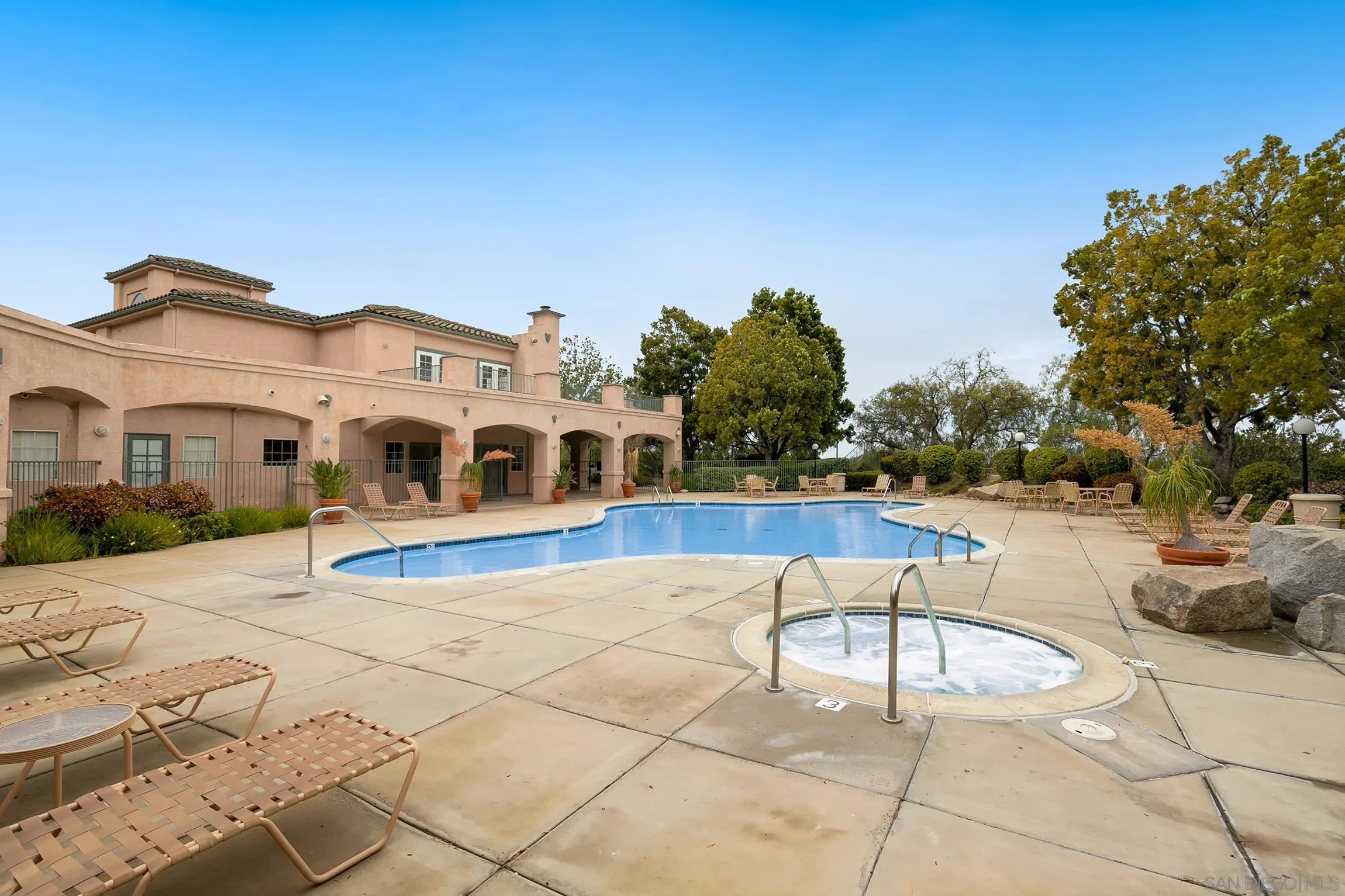17161 Alva Road, Unit 2416 San Diego, CA 92127 - Photo 23 of 26 a view of a white house with a swimming pool and sitting area