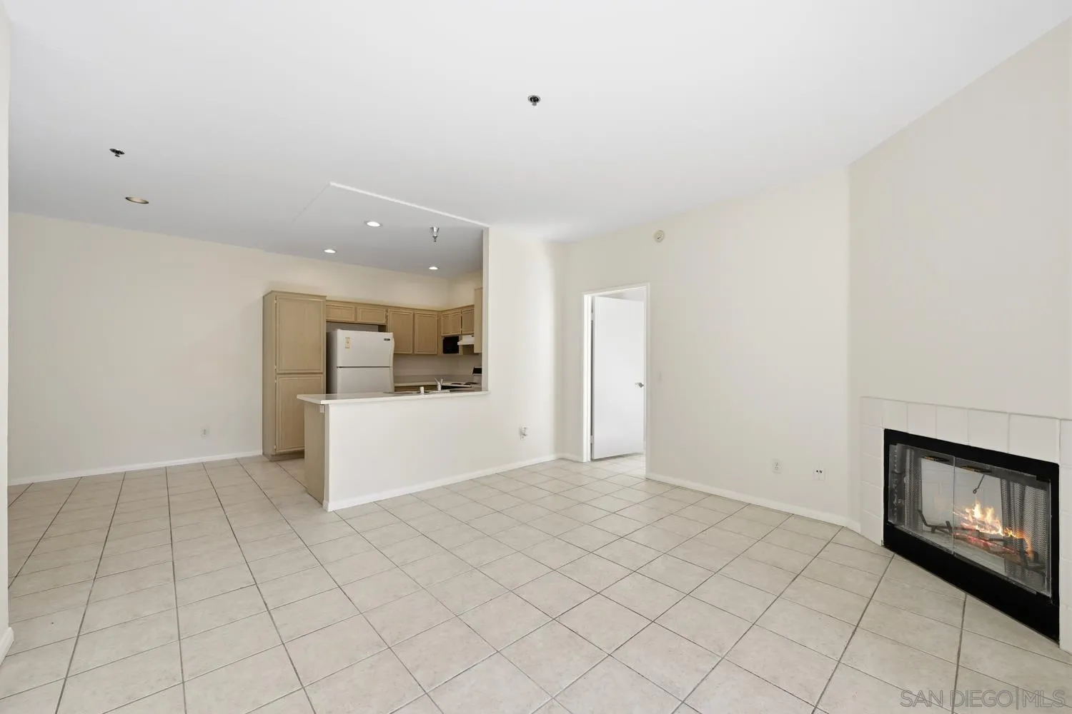 17161 Alva Road, Unit 2416 San Diego, CA 92127 - Photo 10 of 26 a view of an empty room and kitchen with fireplace