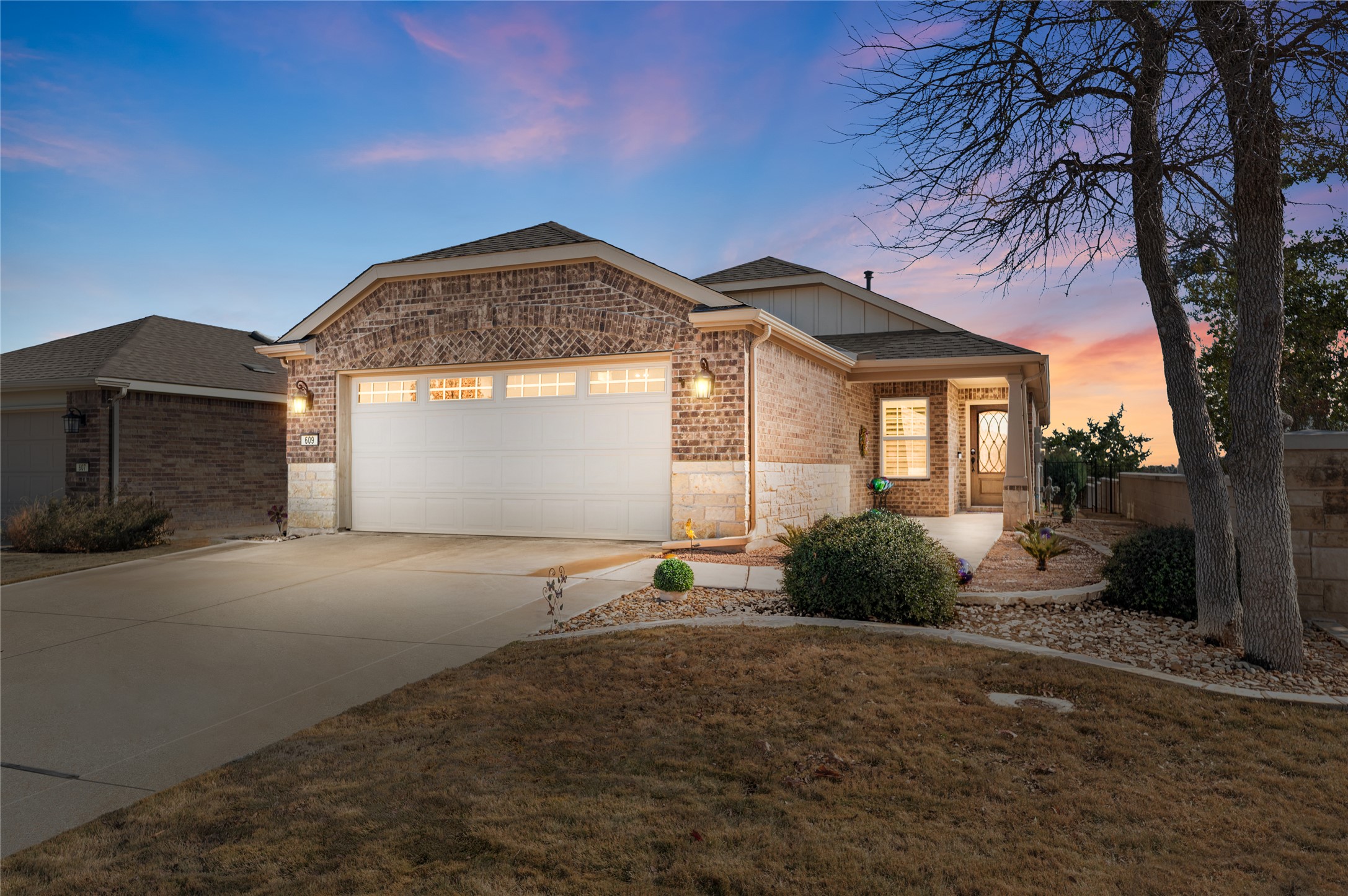 609 Rockport Street Georgetown, TX 78633 - Photo 1 of 1 Ranch-style home featuring driveway, a garage, brick siding, and a shingled roof