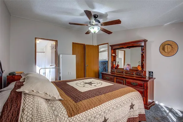 a bed room with a bed mirror and a window