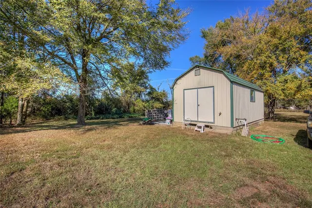 a view of a house with a yard and garage