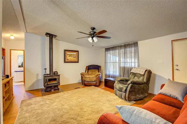 a living room with furniture gym equipment and a window
