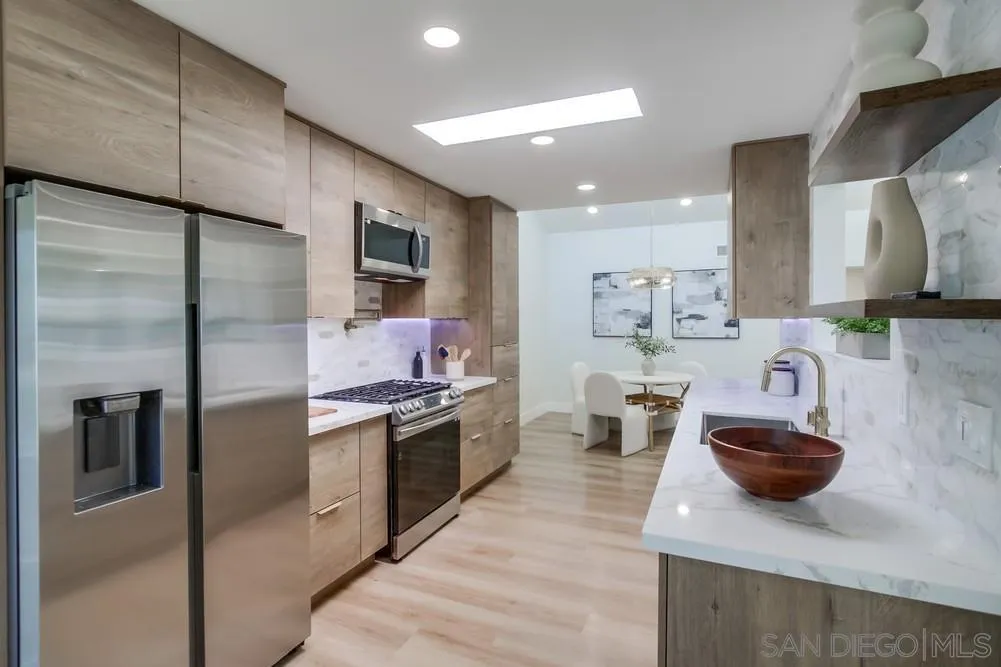 175 Bronze Way Vista, CA 92083 - Photo 1 of 33 a kitchen with stainless steel appliances granite countertop a sink a stove and a refrigerator