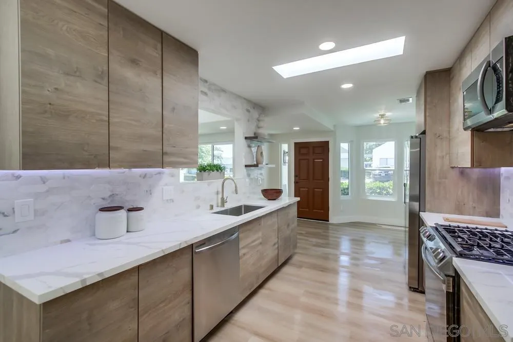 175 Bronze Way Vista, CA 92083 - Photo 2 of 33 a large bathroom with a granite countertop sink a toilet a mirror and shower