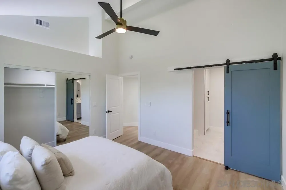 175 Bronze Way Vista, CA 92083 - Photo 21 of 33 a bedroom with a bed and a shower