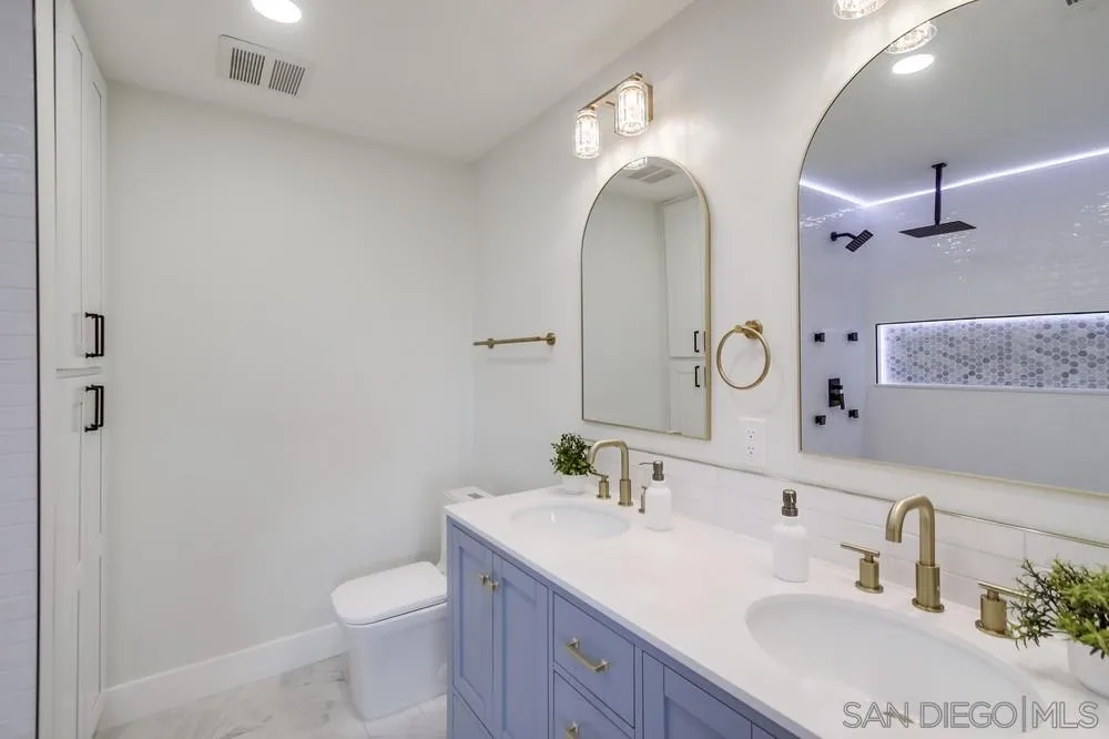 175 Bronze Way Vista, CA 92083 - Photo 23 of 33 a bathroom with a double vanity sink toilet and a mirror