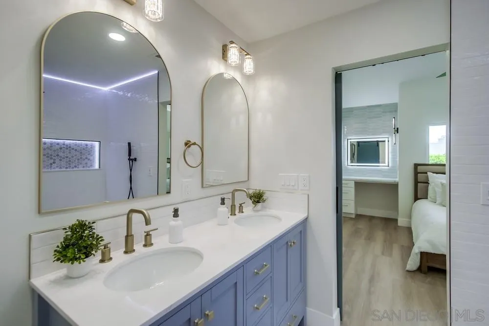 175 Bronze Way Vista, CA 92083 - Photo 25 of 33 a en suite bathroom with double vanity sinks and a mirror