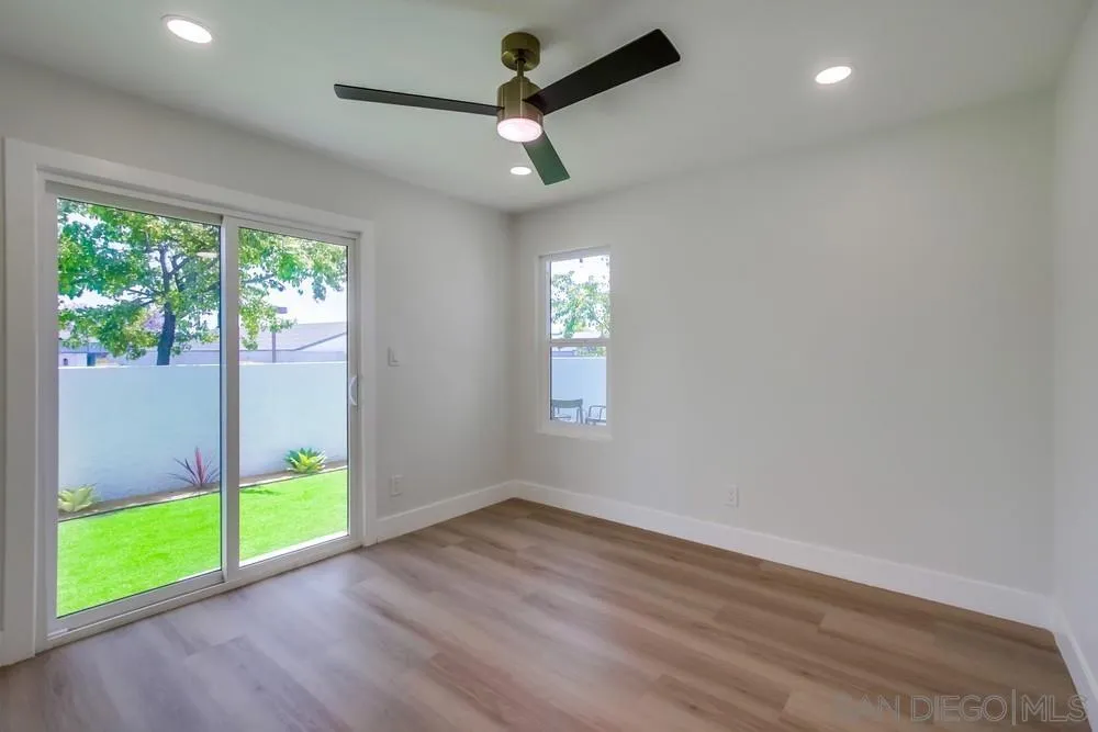 175 Bronze Way Vista, CA 92083 - Photo 26 of 33 a view of an empty room with wooden floor and a window