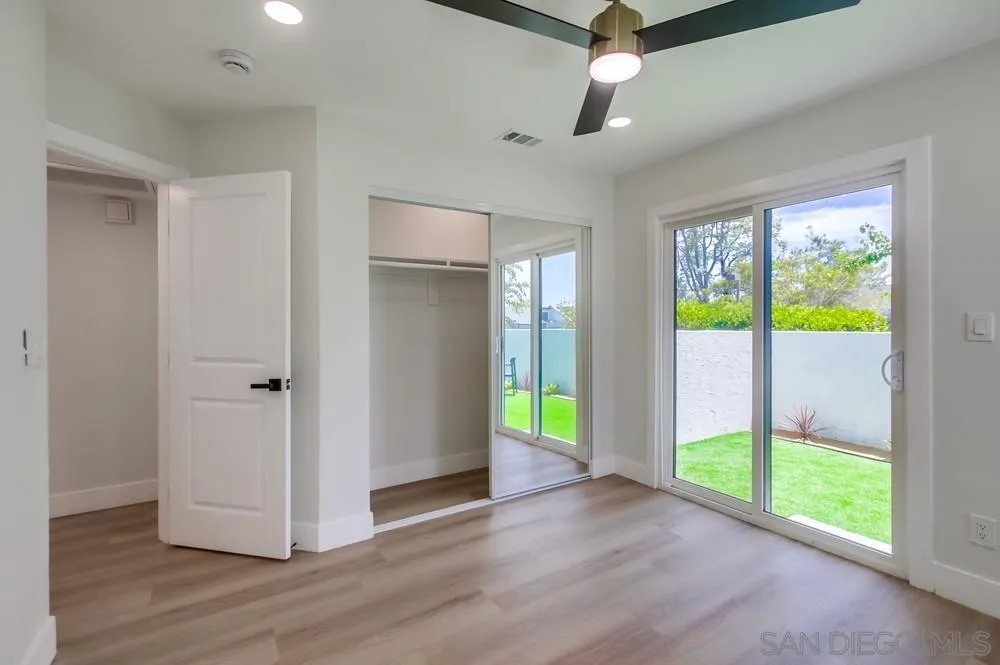 175 Bronze Way Vista, CA 92083 - Photo 27 of 33 a view of an empty room with a window and wooden floor