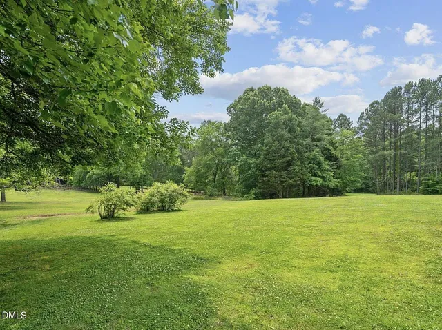 a white house with a large pool