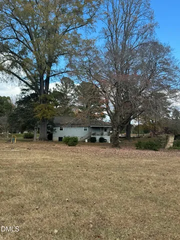 a kitchen with granite countertop white cabinets and appliances