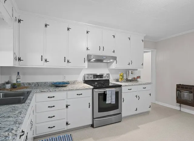 an empty room with a chandelier fan and windows