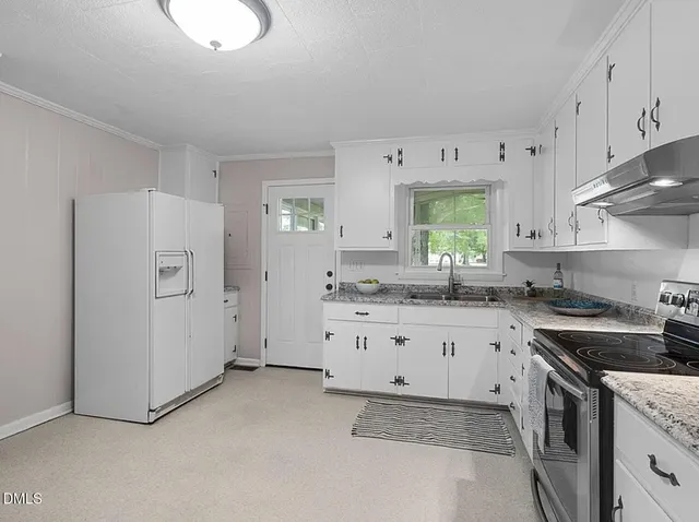 an empty room with chandelier fan