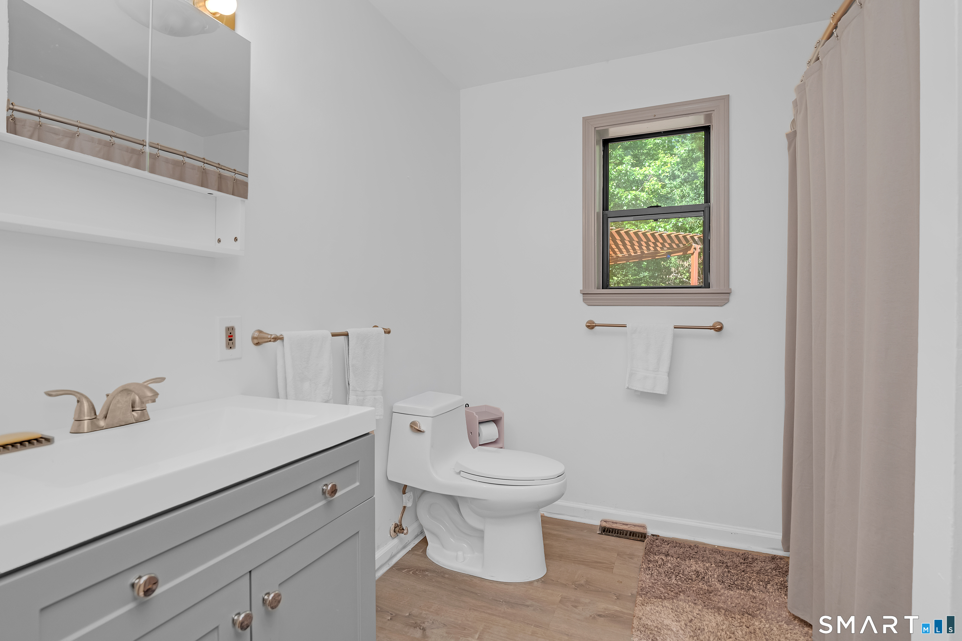 90 Bell Street Manchester, CT 06040 - Photo 19 of 40 a bathroom with a sink a toilet and a mirror